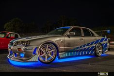 two cars parked next to each other in a parking lot at night with the caption that reads,