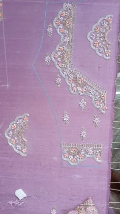 a purple piece of cloth that has been stitched together with beads and sequins