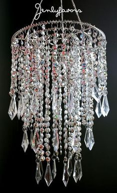 a chandelier hanging from the ceiling with crystal beads and crystals on it's sides