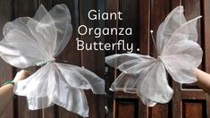 two butterflies made out of organe bags with words written on the wings that say, giant organza butterfly