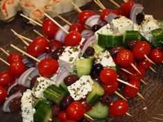 the skewers are filled with different kinds of vegetables and toppings on them