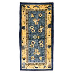 a blue and yellow rug with an intricate design on the center, surrounded by other decorative items