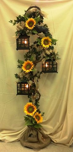 the sunflowers are growing on the side of the wall with lanterns in them