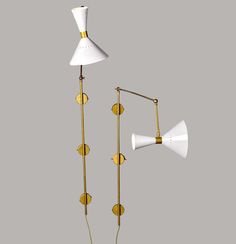 two brass and white wall lamps, one with an arm lamp on the other side