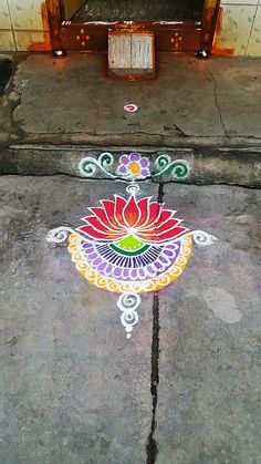 a colorful flower design painted on the sidewalk