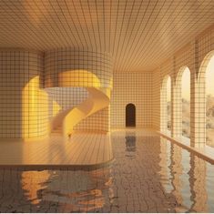 an indoor swimming pool with tiled walls and floor