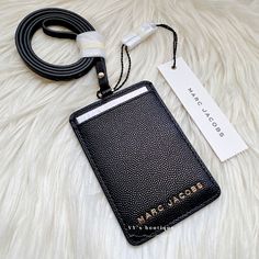 Color: Black Material: Pebble Leather Condition: Brand New With Tag Style No: M0016992 Dimensions: 2.62"W X 3.87"L Lanyard Strap: 17.5" Drop Gold Tone Hardware Id Card Slot 100% Authentic Price Is Firm Comes From Clean & Pet Free Environment Sold Out Everywhere Rare Find Black Card Holder With Key Chain For Everyday Use, Black Badge Holders With Card Slots For Everyday Use, Marc Jacobs Keychain Wallet, Adjustable Black Lanyards With Key Clip, Rectangular Black Leather Luggage Tag, Jacob Black, Key Card Holder, Card Case, Pebbled Leather