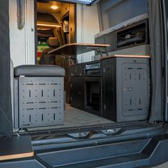 the inside of a van with an oven and microwave in it's back door