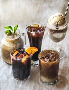 three glasses filled with different types of drinks