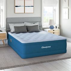 a blue mattress sitting on top of a bed in a bedroom