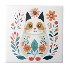 a ceramic tile with an orange and white cat surrounded by flowers