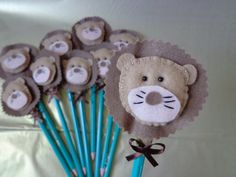 a bunch of blue and brown pencils with stuffed animals on them sitting next to each other