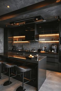 a kitchen with black counter tops and stools next to an island in the middle