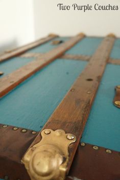 an old trunk is painted blue and gold