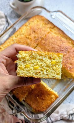 someone holding up a piece of cornbread