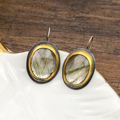 Make a bold statement with these exquisite Prehnite 1.5-inch earrings, elegantly wrapped in 24k gold using the meticulous Korean Keum-boo technique. Each Moss Agate stone showcases unique natural inclusions, making every pair one-of-a-kind. The triangular shape of the stones, paired with the delicate gold wrapping, creates a striking balance of earthy charm and modern sophistication! These earrings are perfect for adding a touch of organic beauty to any outfit, while the 24k gold accents provide a luxurious finish. Lightweight and versatile, they can effortlessly transition from day to night, making them a standout addition to your jewelry collection. Add these Moss Agate earrings to your wardrobe for a timeless yet contemporary look! Keum Boo Jewelry, Keum Boo, Moss Agate Stone, Agate Earrings, Agate Stone, Round Earrings, Moss Agate, Organic Beauty, Ring Bracelet