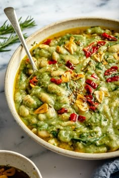 a bowl filled with guacamole and topped with nuts