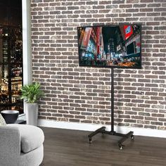 a living room with a brick wall and tv on the stand in front of it