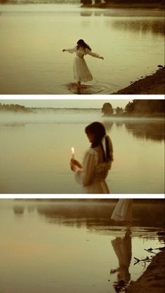 the girl is standing in the water holding a candle