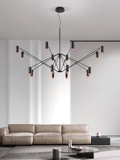 a living room with a couch, coffee table and chandelier hanging from the ceiling