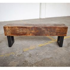 a wooden bench sitting on top of a cement floor