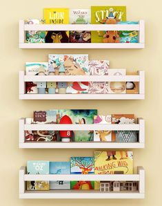 three white bookshelves filled with children's books on top of each other