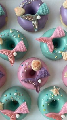 there are many doughnuts decorated with different colors and designs on the top one