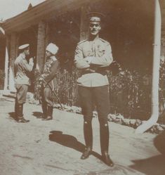 an old black and white photo of two men in uniforms standing next to each other