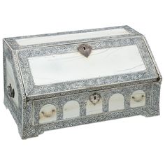 an ornate silver and white box with handles