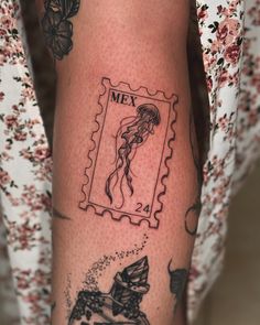 a woman's leg with tattoos on it