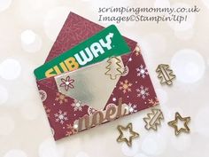 a close up of a christmas card and some magnets on a white background with snowflakes