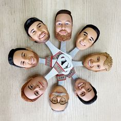 a group of people standing in a circle with faces painted on them