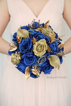 a bride holding a blue and gold bouquet