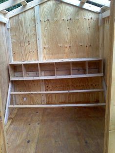 the inside of a wooden storage shed with shelves