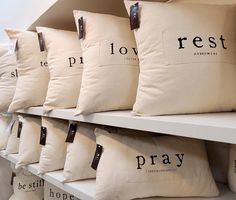 many pillows are lined up on the shelves