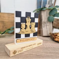 a wooden trophy with a chess piece on it