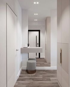 a bathroom with white walls and wood flooring next to a sink in the corner