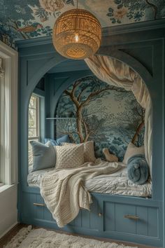 a bedroom with blue painted walls and white bedding, along with a round light fixture hanging from the ceiling