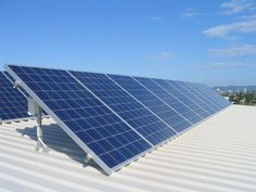 two solar panels on the roof of a building with blue sky in the back ground