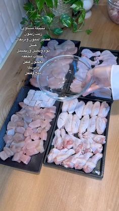 the person is pouring ingredients into trays on the table to make their own meal