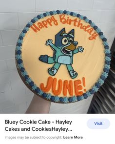 a birthday cake with an image of a cartoon character on the front and back of it