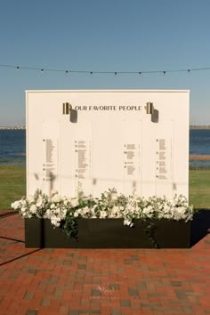 the memorial wall is decorated with white flowers