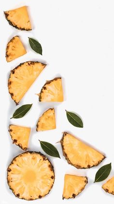 slices of pineapple with leaves on white background