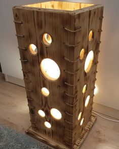 a lamp made out of wood with holes in it