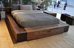 a bed sitting on top of a wooden platform