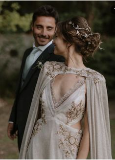 a man in a tuxedo standing next to a woman in a wedding dress