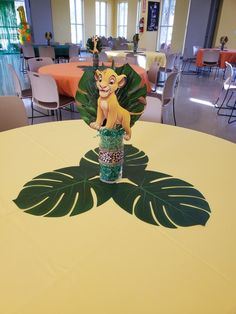 a table with a lion centerpiece on top of it