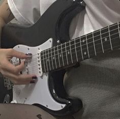 a person is playing an electric guitar