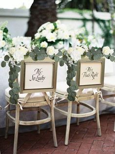 three chairs with signs on them sitting next to each other in front of a table