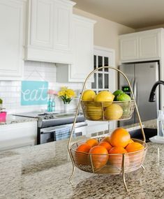 two baskets filled with fruit sitting on top of a kitchen counter